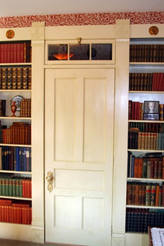 Flat panel door with flanking bookcases